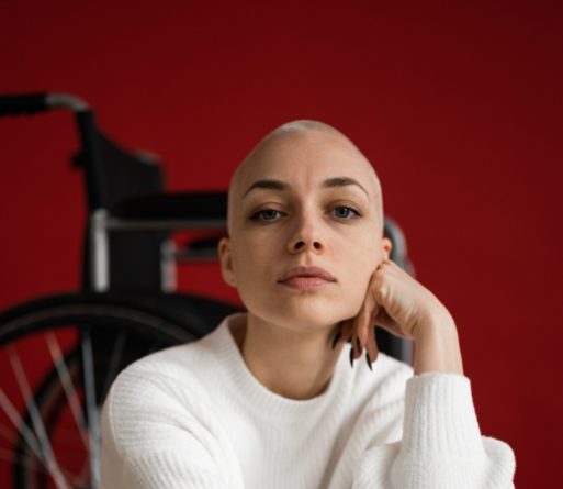 young adult with no hair demonstrates cancer survivorship