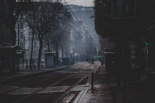 A gloomy street scene of an old city in the rain.