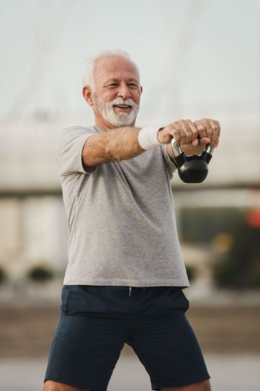 elderly man strength training with kettleball