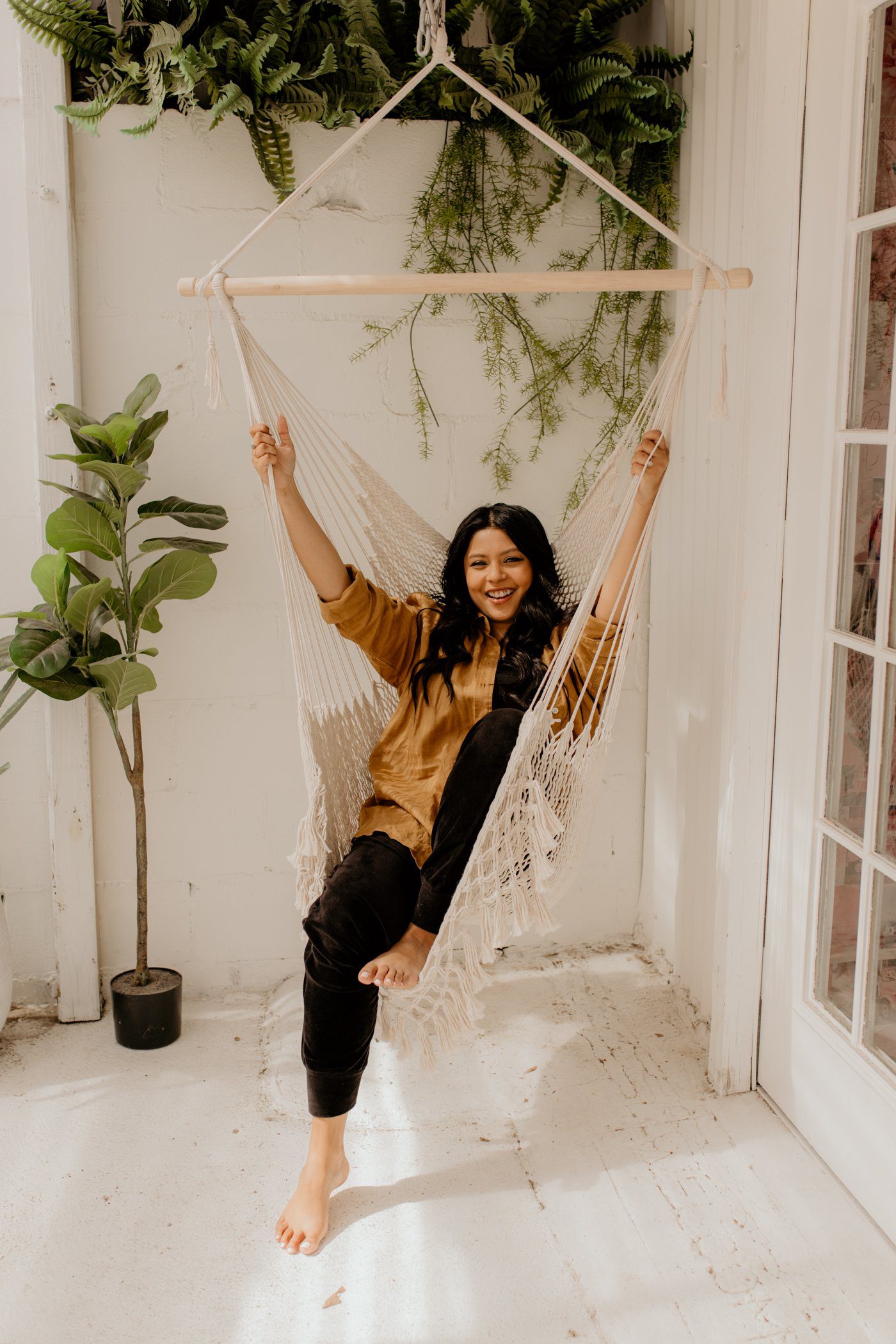 Shanila Sattar, author of "Breathe," poses in a hammock swing.