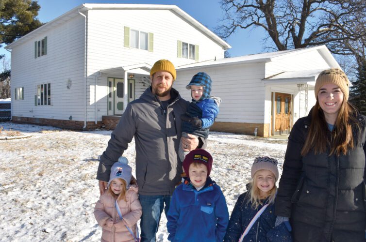 Johnson family stands in front of their repurposed funeral home