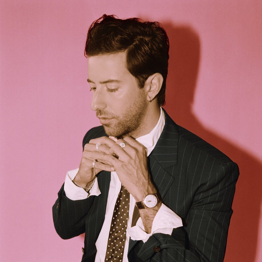 Bruno Major, who sings "Places We Won't Walk," adjusts his tie.