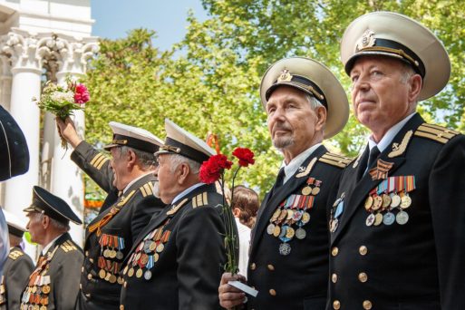 Decorated veterans standing in a Veterans Day parade