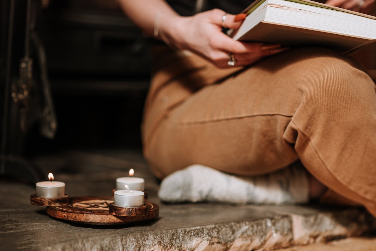 A woman writes New Year's resoutions by candlelight.