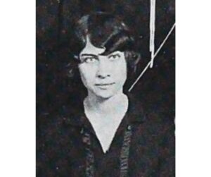 A woman, Clare Harner Lyon, the author of the poem "Immortality," is depicted in 1920's garb in a black and white yearbook photograph. She has a short haircut is looking into the camera lens. 