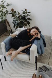 A woman lays on a chair, experiencing autistic grief.