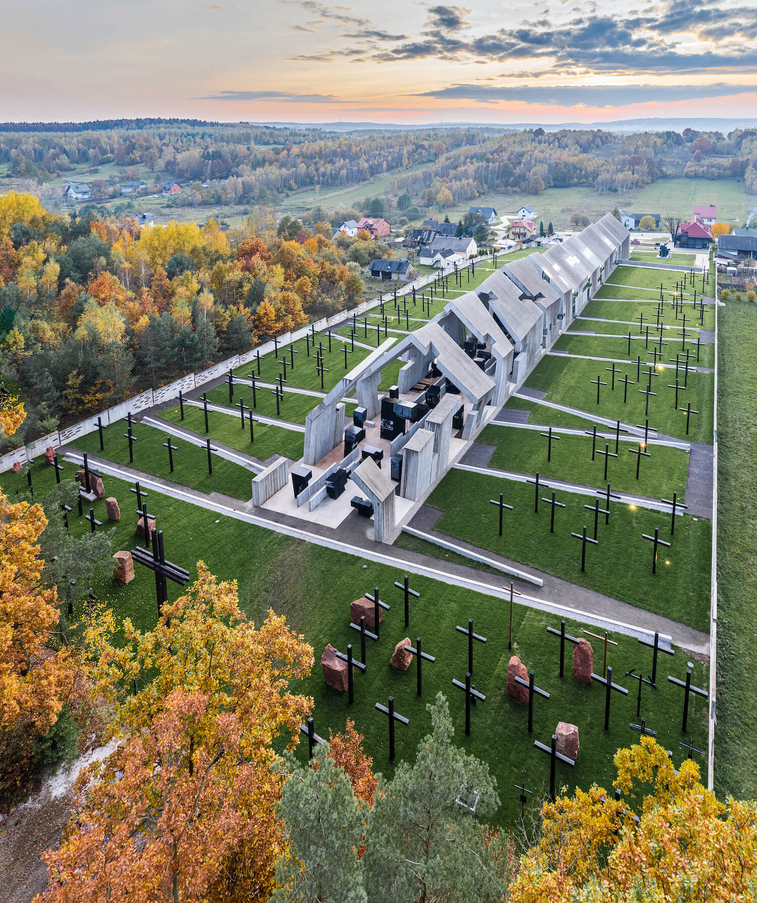 In an overhead shot, we can better see the degraded aspect of the sculptural portion of the Mausoleum. There are black concrete blocks displaying photos and art in a room constructed without a roof or even walls.