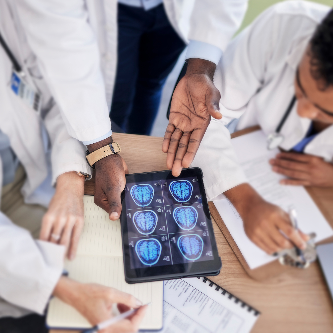 Scientists in white lab coats are reviewing images of a scan of the human brain trying to contemplate our own mortality