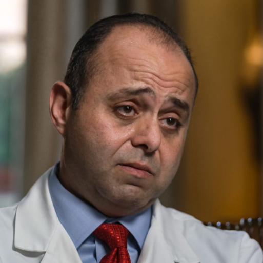 A doctor, Ghasan Tabel, looks just off to the side of the camera while being interviewed about speaking against HCA's unethical hospice care practice.