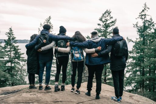 loved ones share a group hug during a memorial hike