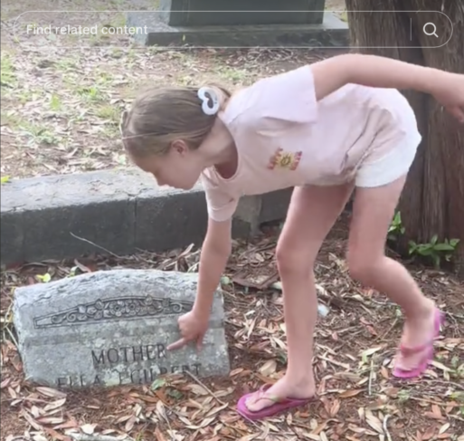 Haley Hodge daughter explores cemetery.