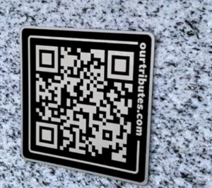 A QR code on a gravestone at a burial site illustrates the use of AI.