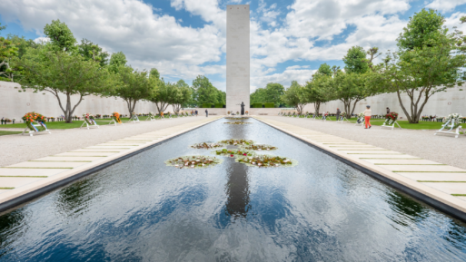 The tower monument of the Netherlands American Cemetery is reflected in a shallow pool 