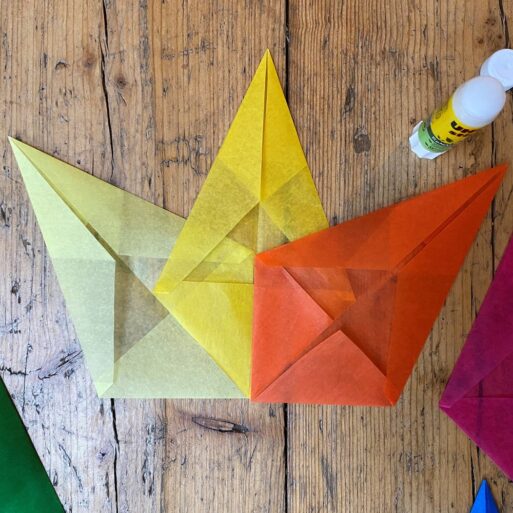 Tissue paper is folded into diamonds that get glued together to make these stars