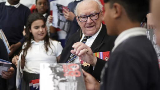 D-Day veteran and Ambassador for the British Normandy Memorial Ken Hay speaks to children during a visit to Rush Green Primary School in Dagenham, England 