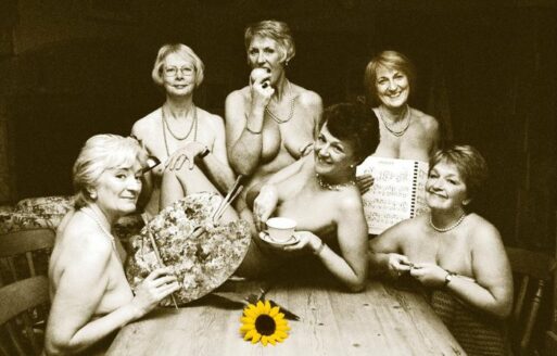 Six women pose nude behind carefully placed props in a black and white photo