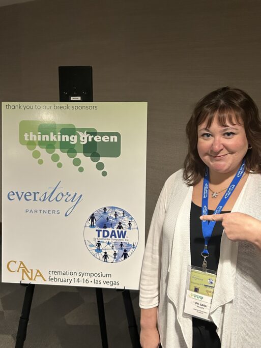 Sara Murphy, an expert on suicide grief, pictured next to a poster at a cremation symposium.