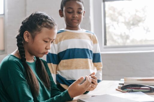 A young girl and her friend play Minecraft on her phone to process their grief.