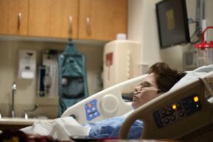 A person lying in a hospital bed