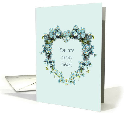 A light green greeting card has a floral heart in the center, with the words, "You are in my heart" printed inside