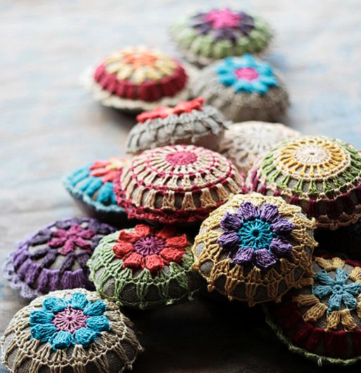 A pile of crocheted memory stones in vibrantly different colors.