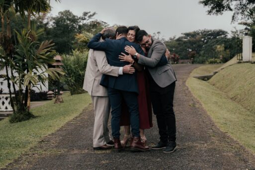 An eco-chaplain gathers others in a group hug.