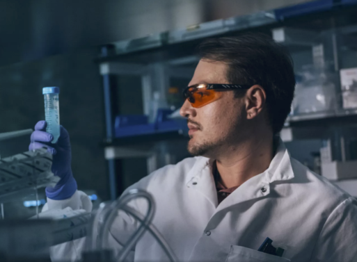 Lab technician examining a test tube at Altos Labs.doing longevity research