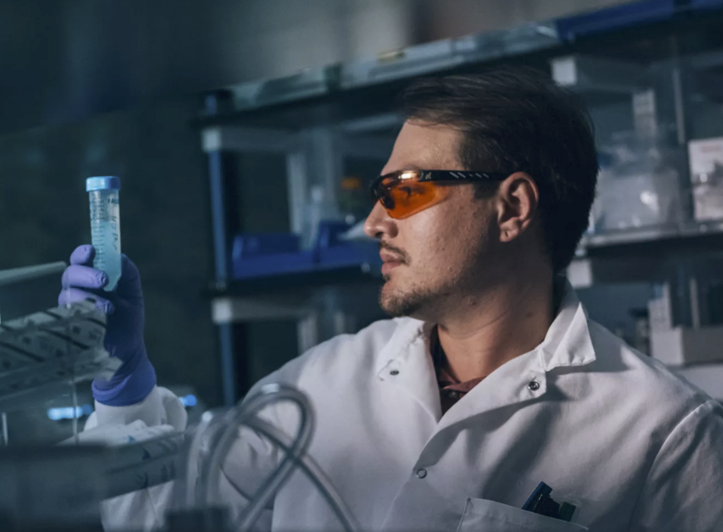 Lab technician examining a test tube at Altos Labs.doing longevity research