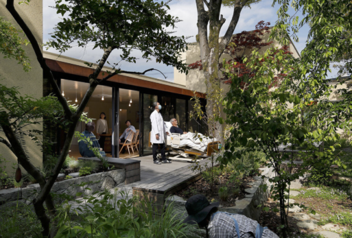 A patient and doctor view a garden from a deck at the Kawamura Hospice.