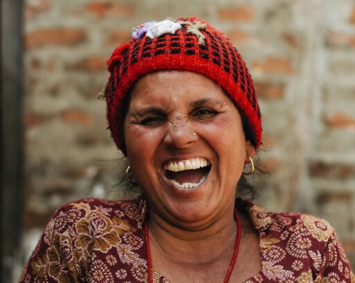 Laughing woman in red cap.