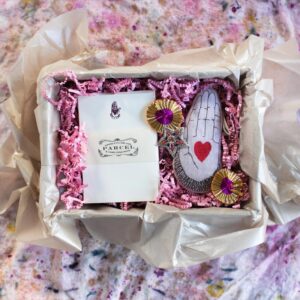 A gift box with peaceful hand ornament and box of notecards