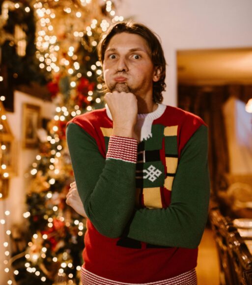 Stressed out man in front of Christmas decorations