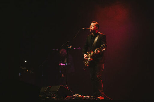 Jason Isbell on stage singing.