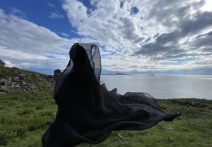 Doll of a keening woman wrapped in black fabric on a Scottish Loch