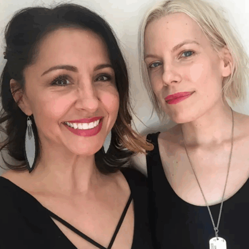 Two women - one brunette and the other platinum blond - pose together for a selfie. They're both smiling, and seem to be dressed up for some event.