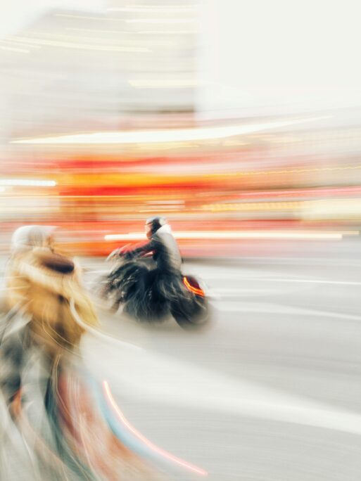 Image of a motorcycle riding through a blur of light
