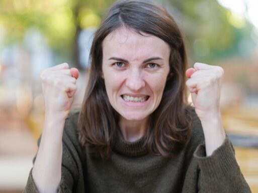 Woman expressing anger from suffering a loss
