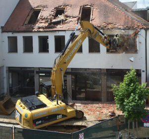 heavy machinery demolishing a building