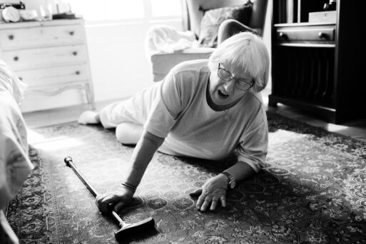 old woman with cane on the floor after a fall