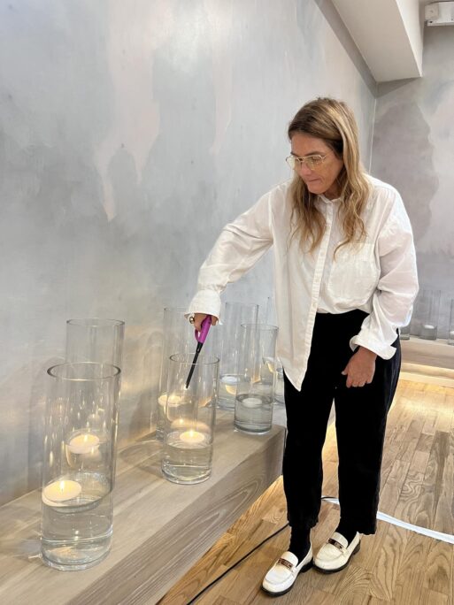 Erica lighting candles at her modern funeral home located in New York City