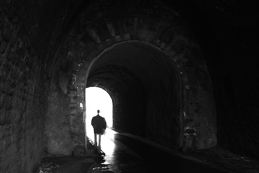 person walking in a tunnel