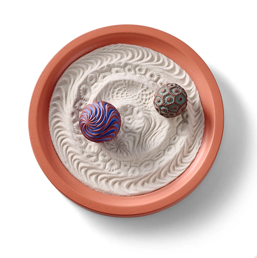 a small sand tray with soothing objects