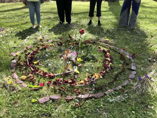 Dried flowers, seed pods, and other items found in nature are arrayed in concentric circles, as a spiral collage made from nature's gifts.