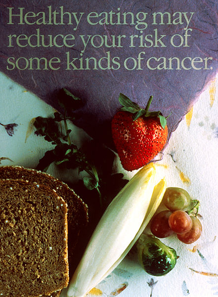 Whole wheat bread, corn a strawberry and grapes, with the caption healthy eating may reduce your risk for some kinds of cancer