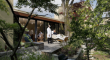 A patient and doctor view a garden from a deck at the Kawamura Hospice.