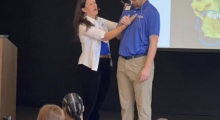 A woman and man onstage at a dementia care training