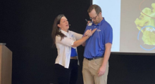 A woman and man onstage at a dementia care training