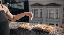 Woman eating on balcony.